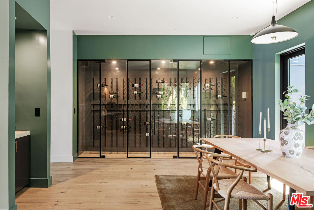 2181 Beech Knoll Road Los Angeles, CA 90046 - Photo 11 of 30 a dining room with glass door and furniture