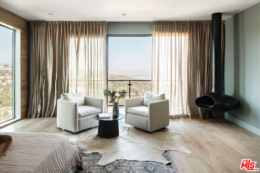 2181 Beech Knoll Road Los Angeles, CA 90046 - Photo 13 of 30 a bedroom with furniture and a large window