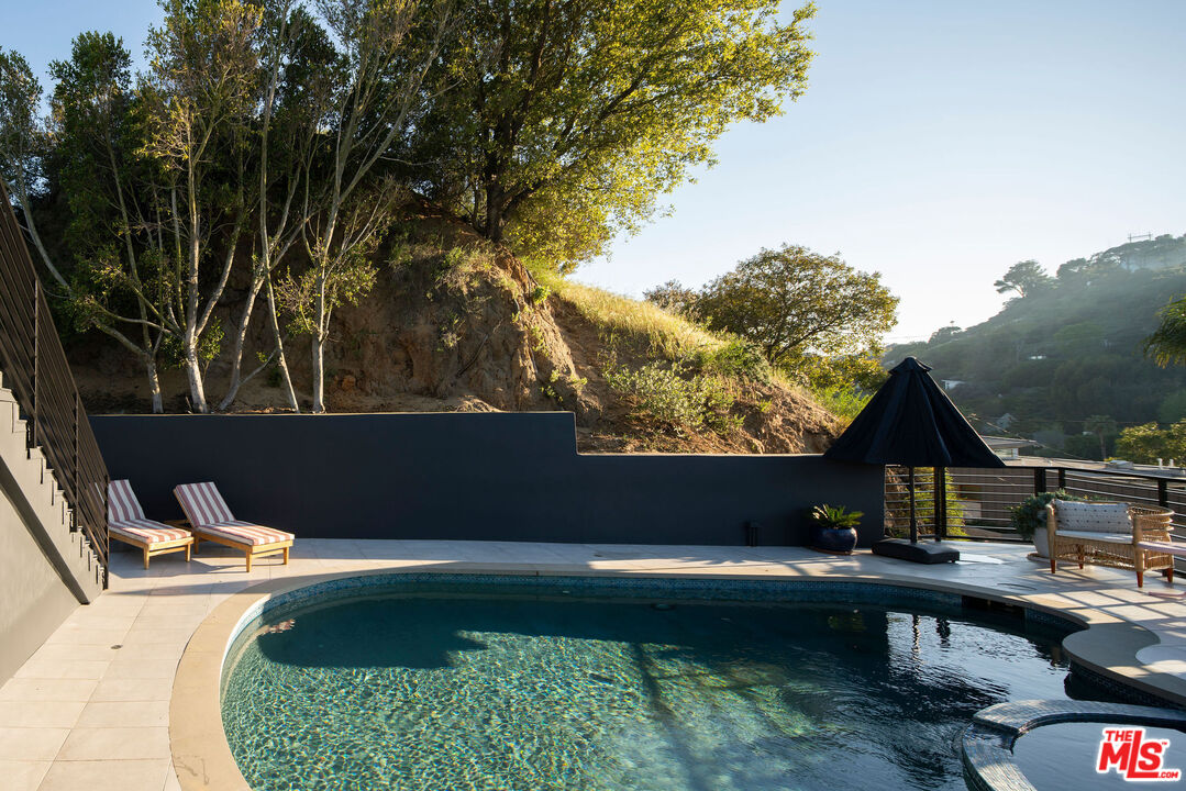 2181 Beech Knoll Road Los Angeles, CA 90046 - Photo 26 of 30 a view of swimming pool with a yard and outdoor seating