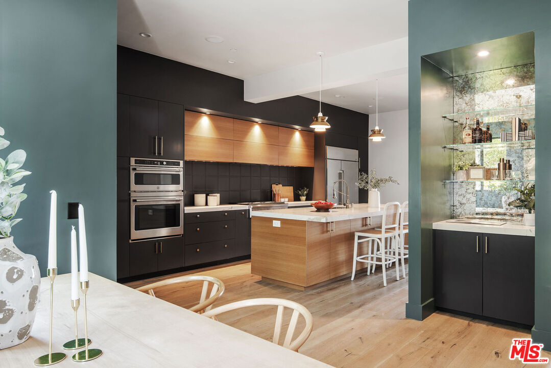 2181 Beech Knoll Road Los Angeles, CA 90046 - Photo 9 of 30 a kitchen with stainless steel appliances kitchen island granite countertop a sink and cabinets