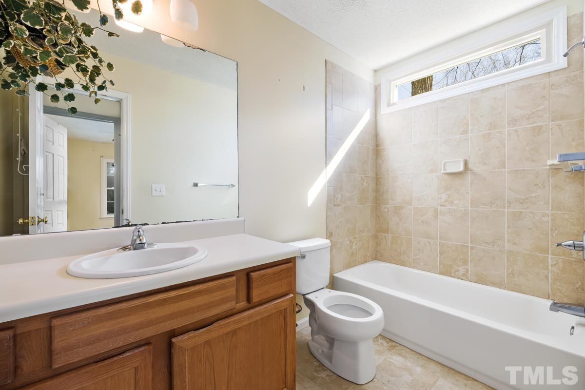 2104 Havering Place Raleigh, NC 27604 - Photo 9 of 13 a bathroom with a sink a toilet and a bathtub