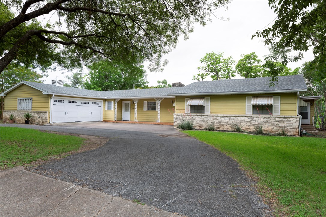 a front view of house with yard and green space