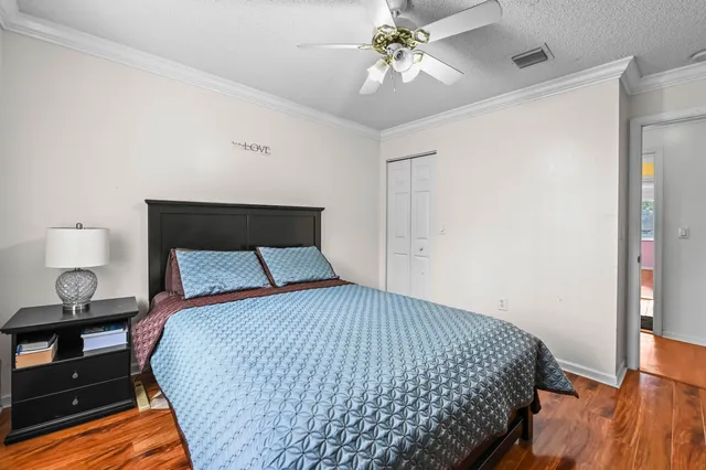 a bedroom with a bed and wooden floor