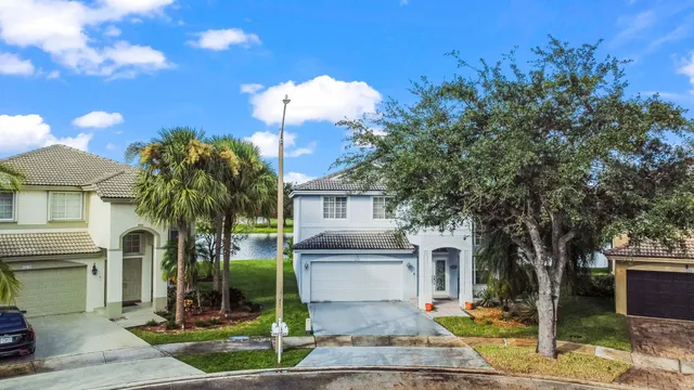 an aerial view of residential houses with outdoor space and lake view