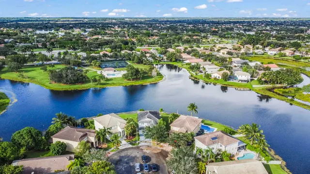 an aerial view of residential houses with outdoor space and swimming pool