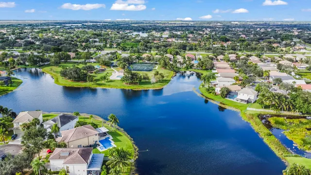 an aerial view of a house with a yard and lake view