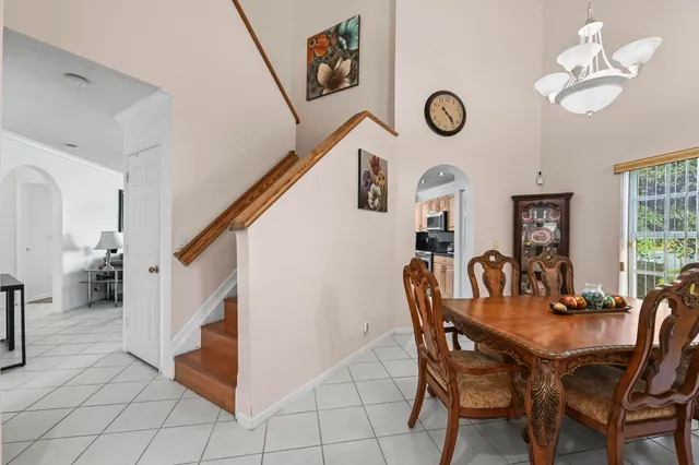a view of a dining room with furniture and a chandelier