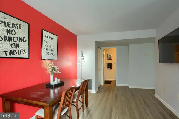 a view of a livingroom with furniture wooden floor and wall painting