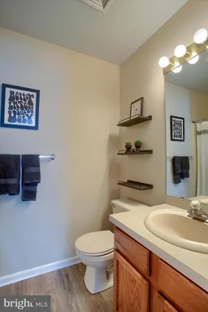 a bathroom with a sink a toilet and mirror