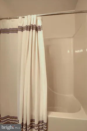 a bathroom with a shower and a bathtub