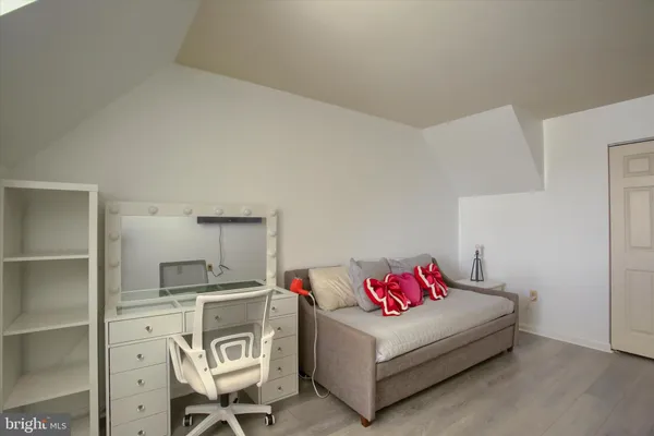 a bedroom with a bed and a couch