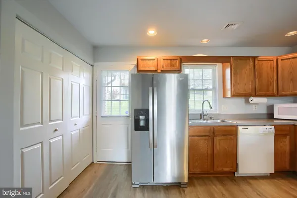 a kitchen with stainless steel appliances granite countertop a refrigerator and a sink