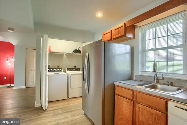 a kitchen with stainless steel appliances granite countertop a refrigerator a sink and a stove