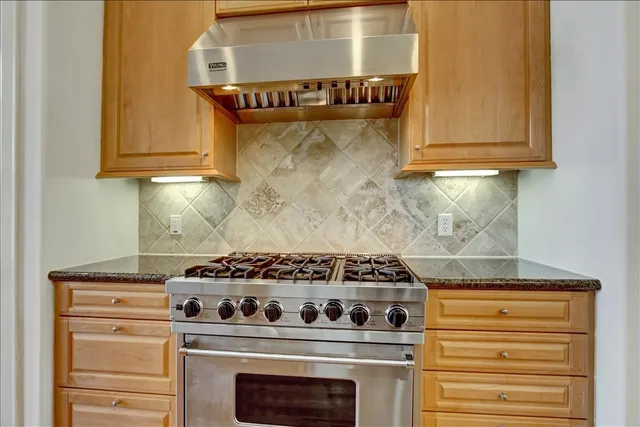 a stove top oven sitting inside of a kitchen
