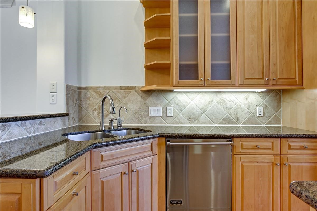 2318 Welch Street Houston, TX 77019 - Photo 15 of 35 Main stainless double sink, under counter lighting, glass door cabinets, art niches & satin fixtures