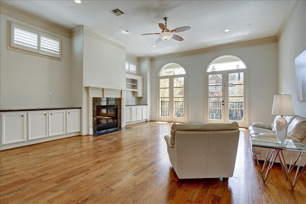 2318 Welch Street Houston, TX 77019 - Photo 18 of 35 Well appointed Gaslog fireplace, multiple French doors to balcony & rich hardwoods throughout