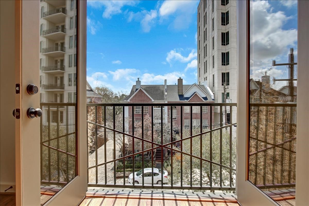 2318 Welch Street Houston, TX 77019 - Photo 23 of 35 Primary bedroom on third floor balcony overlooking southeast views & window treatments 2026