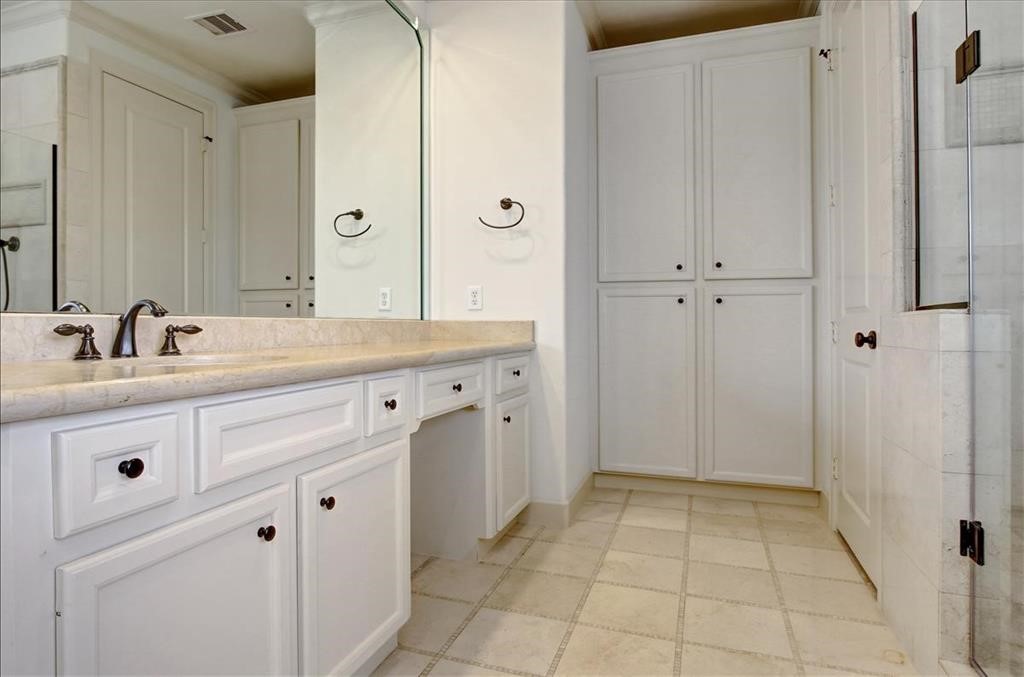2318 Welch Street Houston, TX 77019 - Photo 25 of 35 Executive primary bathroom with double sink marble counters, tiled floors, bronze fixtures & custom built-ins