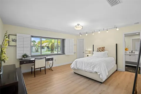 a bedroom with a bed and a table