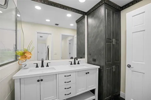 a bathroom with a double vanity sink mirror and double