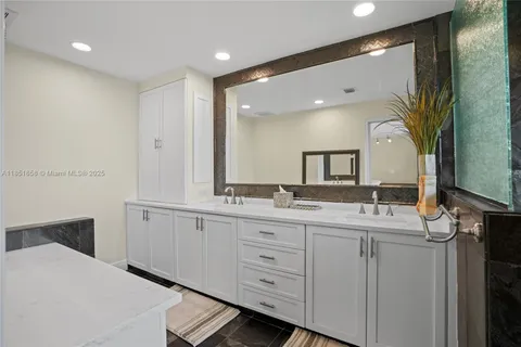 a bathroom with a double vanity sink and a mirror