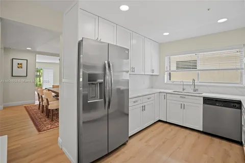 a kitchen with a refrigerator a sink and dishwasher