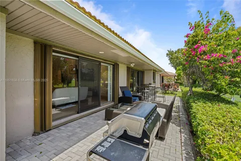 a view of a patio with table and chairs and potted plants