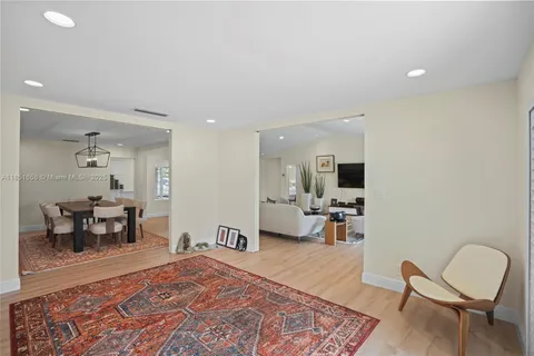 a living room with furniture and a dining table