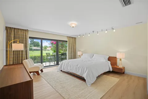 a bedroom with a bed and glass window