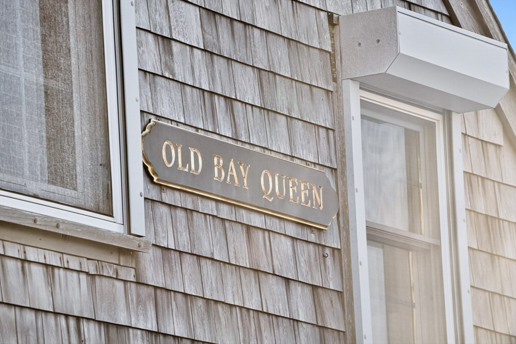1145 Kingsbury Beach Road Eastham, MA 02642 - Photo 38 of 42 a sign broad of a wooden door