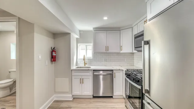 a kitchen with a sink and white cabinets