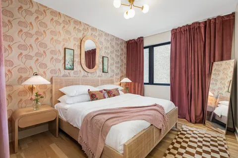 a bedroom with a bed and a mirror