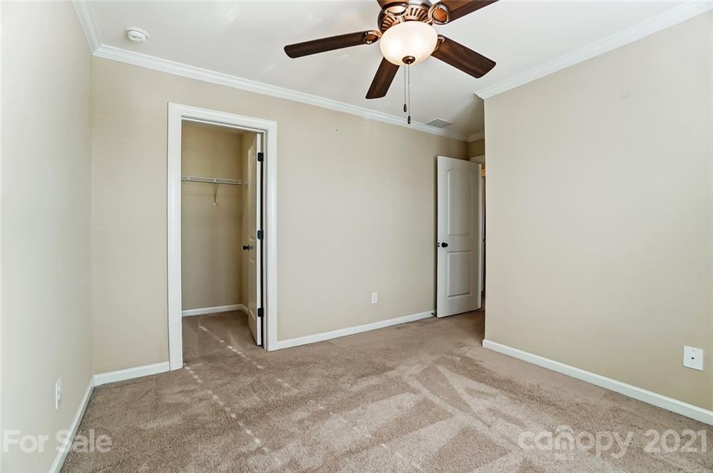 1413 Calum Way Fort Mill, SC 29708 - Photo 22 of 34 an empty room with ceiling fan and window