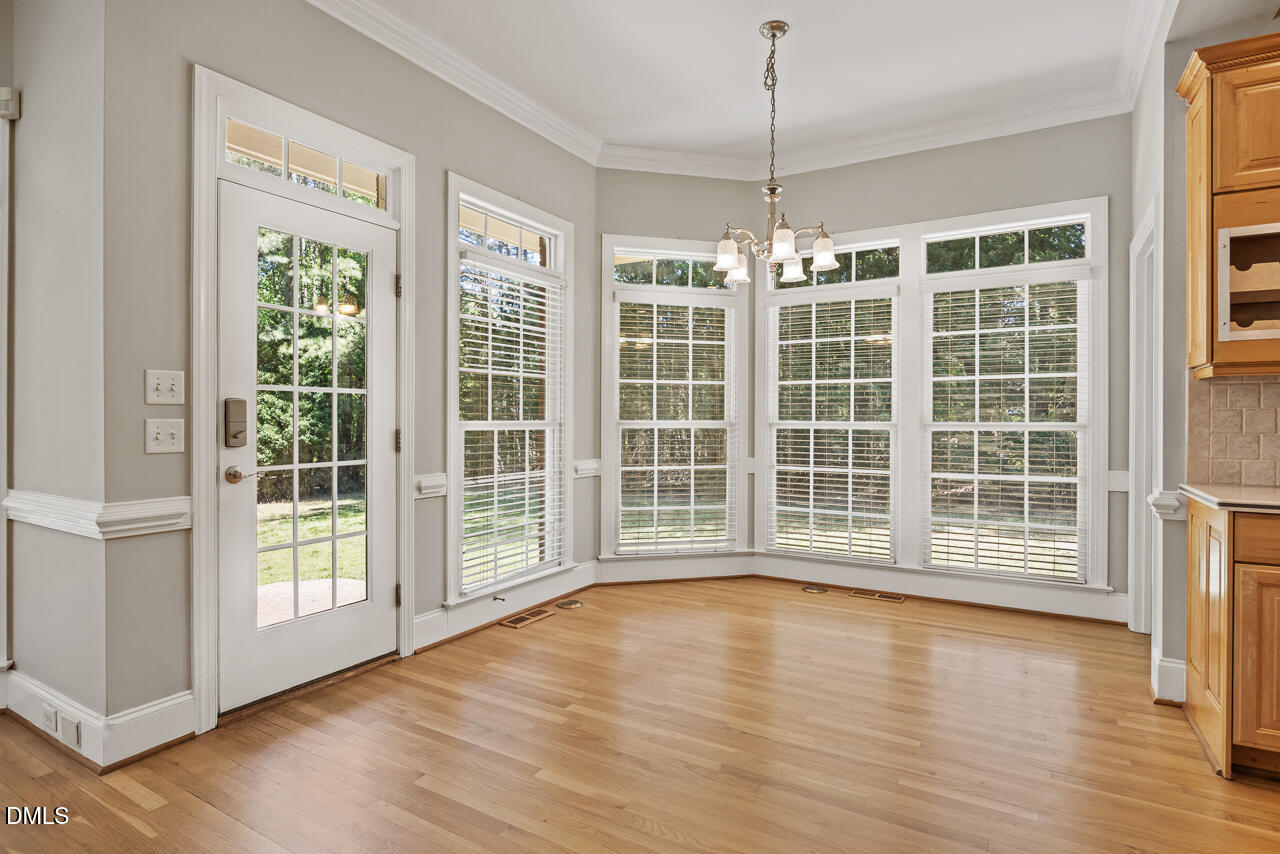 4004 Frontenac Court Apex, NC 27539 - Photo 24 of 61 a view of an empty room with wooden floor and a window