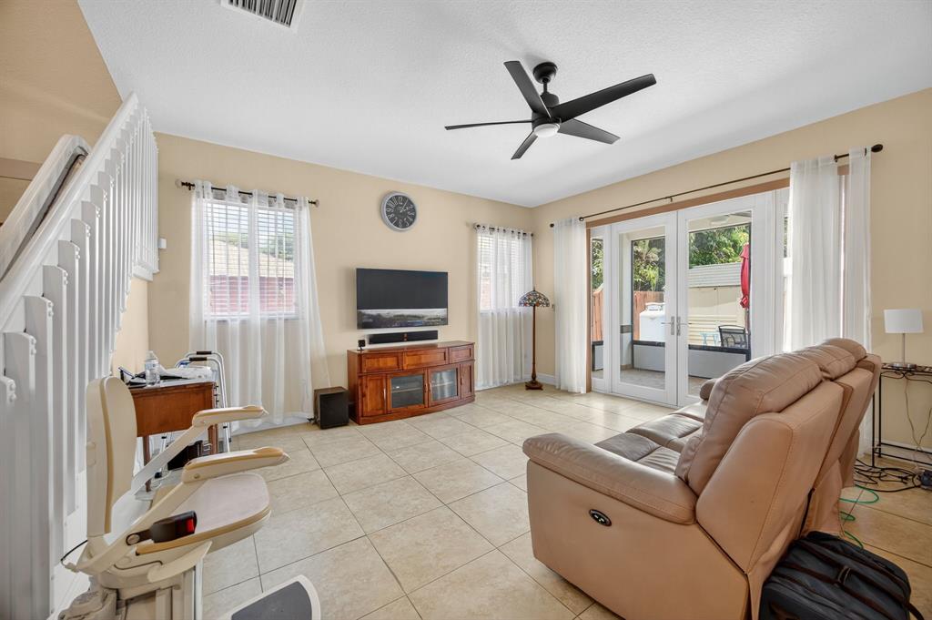 18203 Southwest 152nd Place Miami, FL 33187 - Photo 20 of 55 a living room with furniture and a flat screen tv