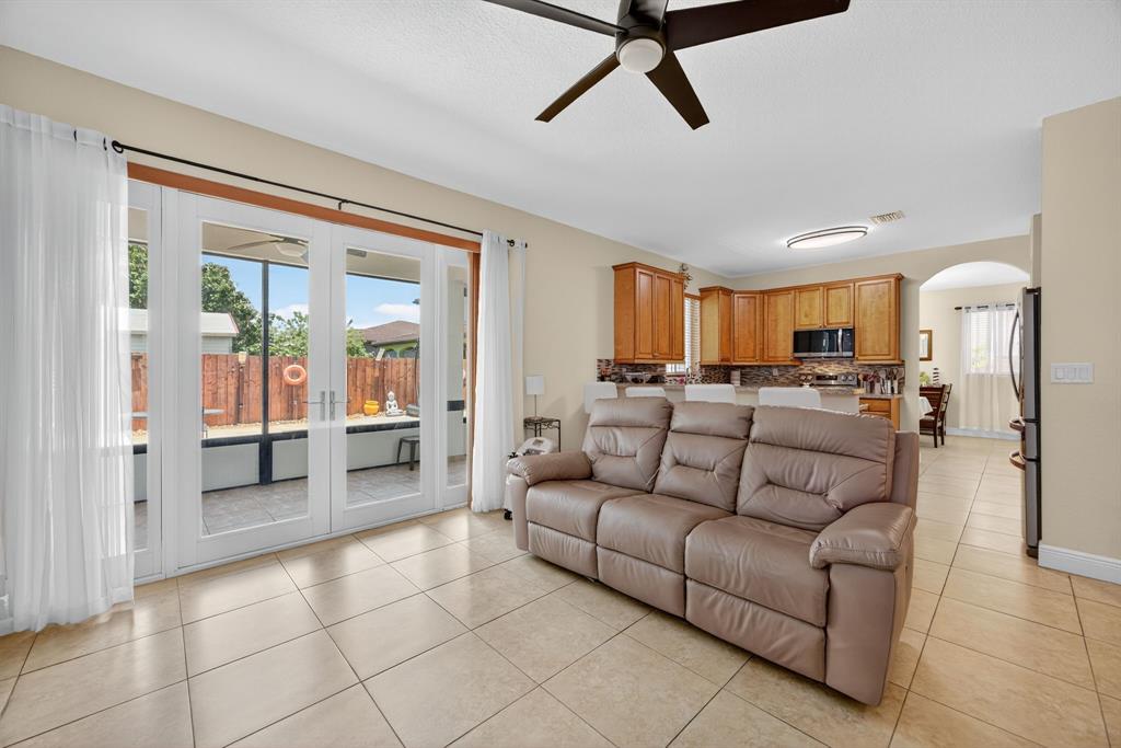 18203 Southwest 152nd Place Miami, FL 33187 - Photo 24 of 55 a living room with furniture and a large window