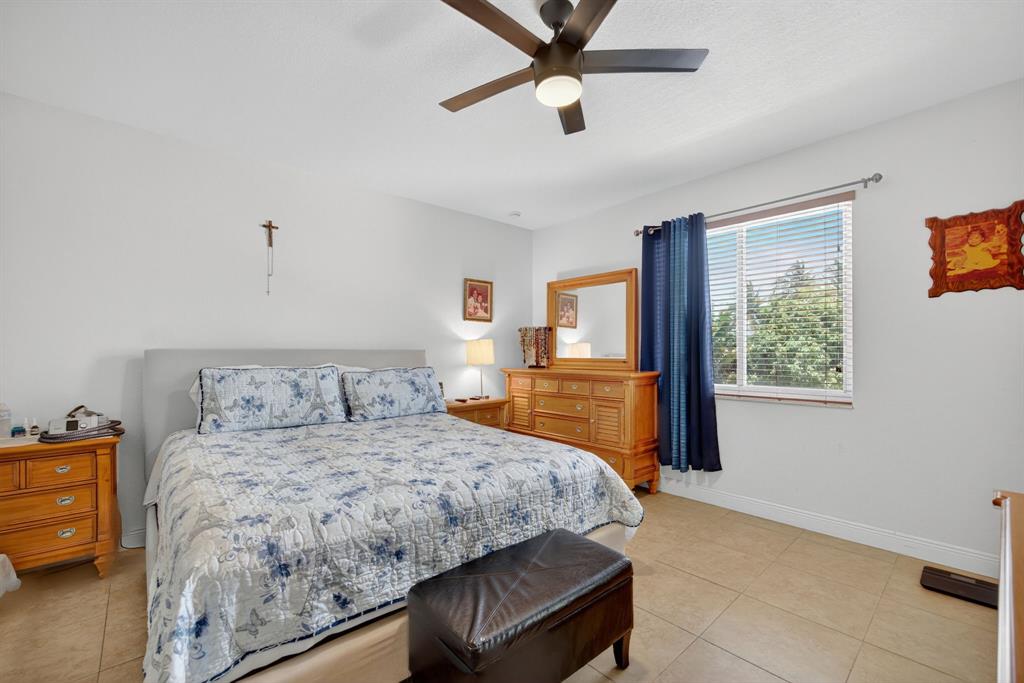 18203 Southwest 152nd Place Miami, FL 33187 - Photo 26 of 55 a bedroom with a bed and a view of kitchen