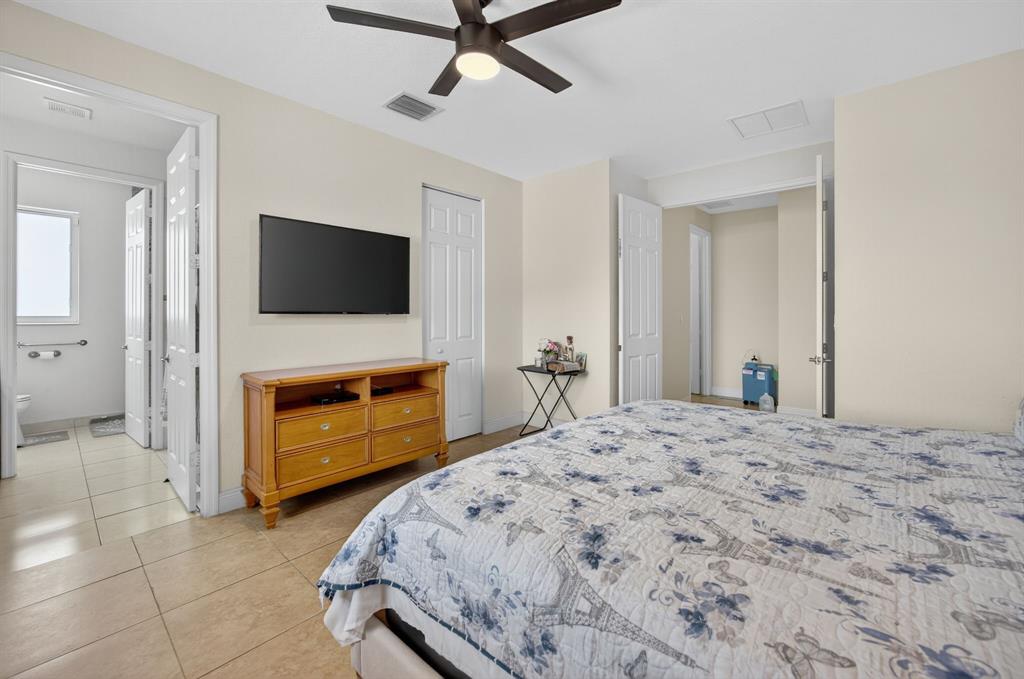 18203 Southwest 152nd Place Miami, FL 33187 - Photo 27 of 55 a bedroom with a bed and a flat screen tv