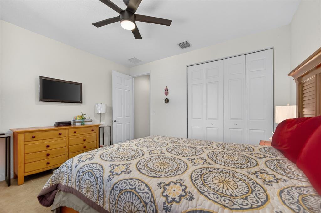 18203 Southwest 152nd Place Miami, FL 33187 - Photo 28 of 55 a bedroom with a bed and a flat screen tv