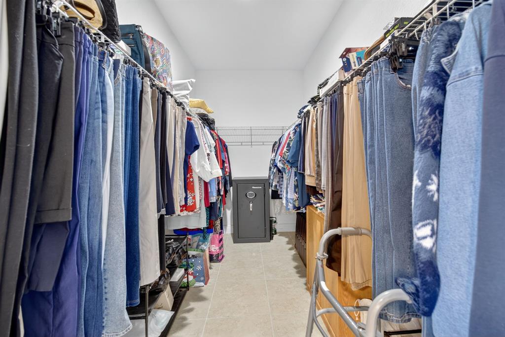 18203 Southwest 152nd Place Miami, FL 33187 - Photo 29 of 55 a view of walk in closet with clothes