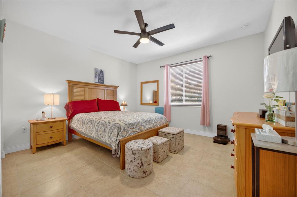 18203 Southwest 152nd Place Miami, FL 33187 - Photo 36 of 55 a bedroom with a bed dresser and a window