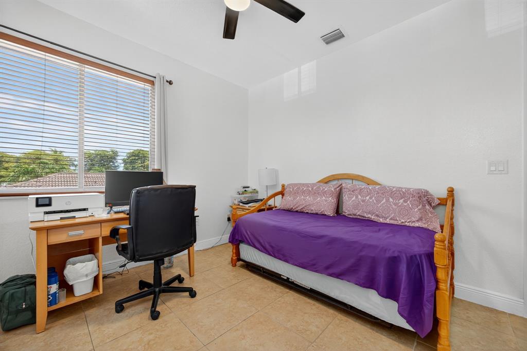 18203 Southwest 152nd Place Miami, FL 33187 - Photo 37 of 55 a bedroom with a bed and a window