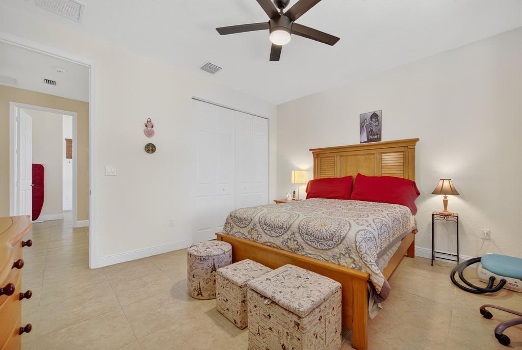 18203 Southwest 152nd Place Miami, FL 33187 - Photo 38 of 55 a bedroom with a bed and ceiling fan