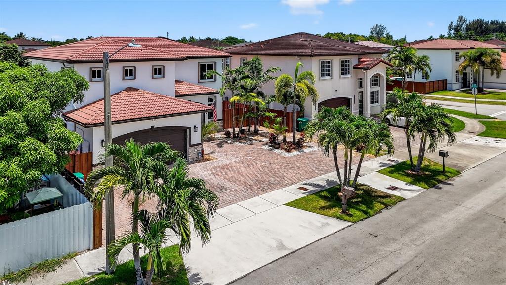 18203 Southwest 152nd Place Miami, FL 33187 - Photo 4 of 55 a front view of a house with garden