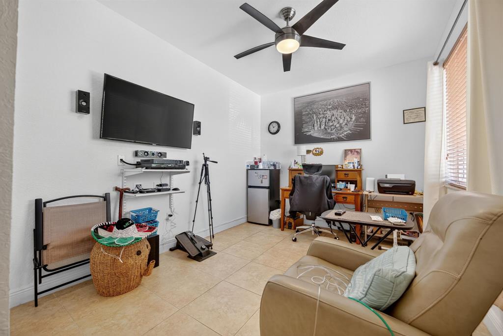 18203 Southwest 152nd Place Miami, FL 33187 - Photo 41 of 55 a view of a livingroom with workspace and a window