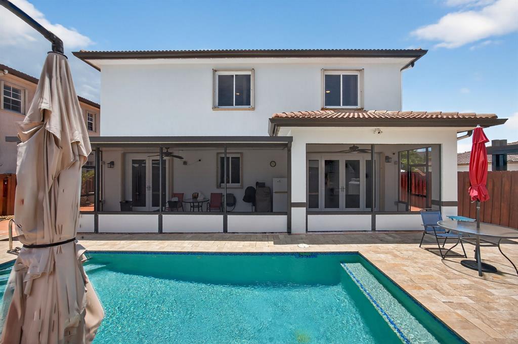 18203 Southwest 152nd Place Miami, FL 33187 - Photo 45 of 55 a view of house with swimming pool outdoor seating