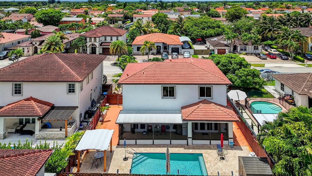 18203 Southwest 152nd Place Miami, FL 33187 - Photo 8 of 55 an aerial view of a house with large trees and a swimming pool