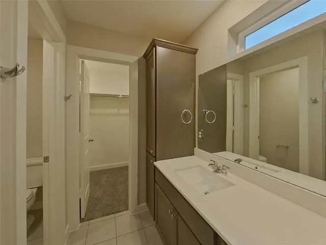 a bathroom with a sink shower and a mirror