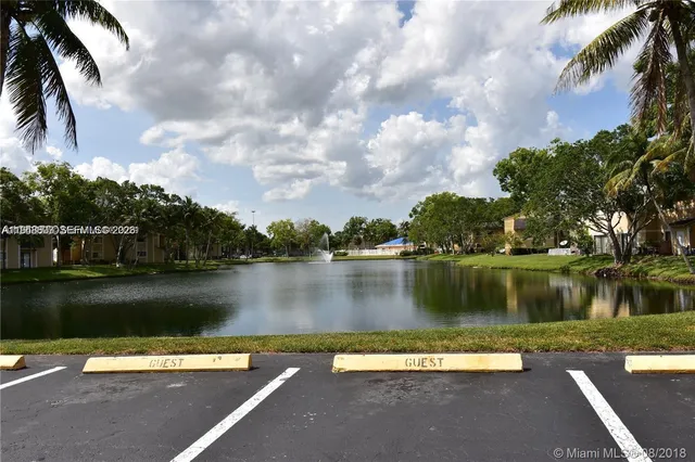 a view of a lake with a yard next to a lake