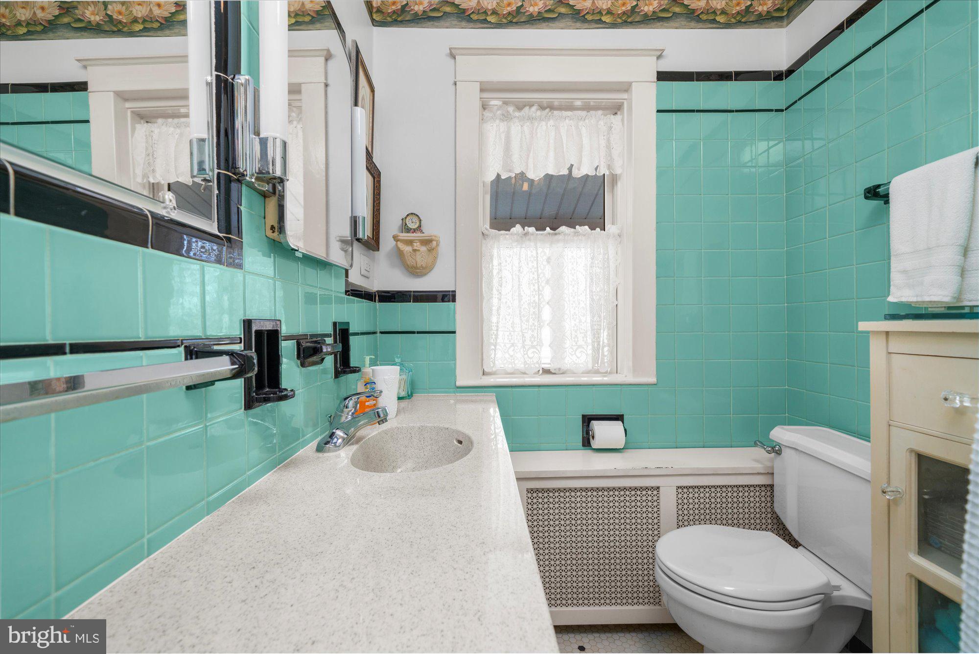3 Reading Avenue Reading, PA 19607 - Photo 21 of 44 a bathroom with a toilet a sink and a mirror